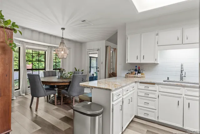 a kitchen with cabinets stainless steel appliances and a sink