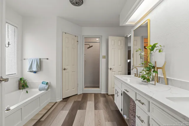 a spacious bathroom with a double vanity sink and a mirror