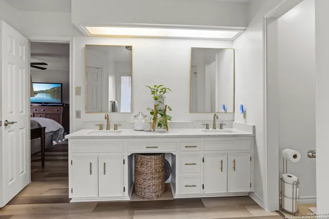 a bathroom with a double vanity sink mirror and toilet