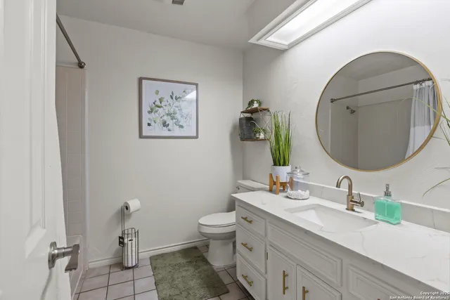 a spacious bedroom with a bed and a chandelier