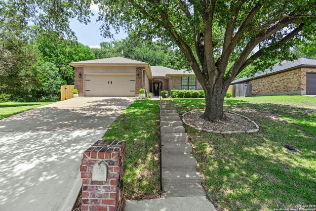 a front view of house with a garden