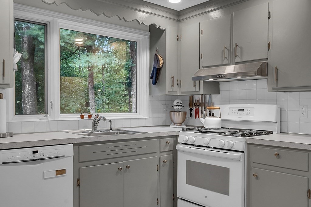24 Whippletree Road Chelmsford, MA 01824 - Photo 11 of 34 a kitchen with appliances cabinets and a large window
