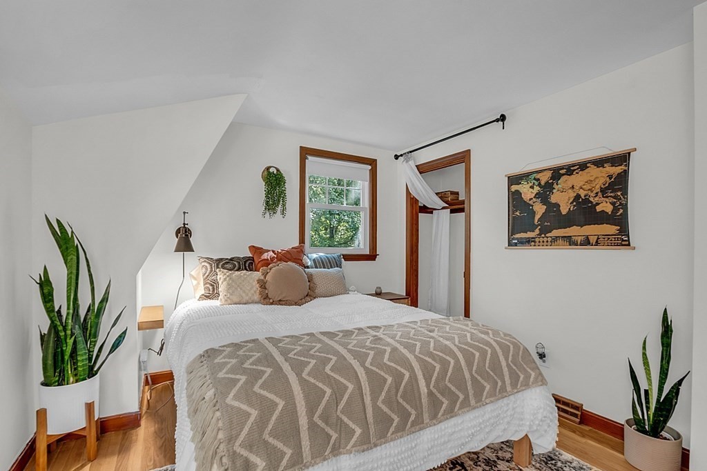 24 Whippletree Road Chelmsford, MA 01824 - Photo 27 of 34 a bedroom with a large bed and a potted plant
