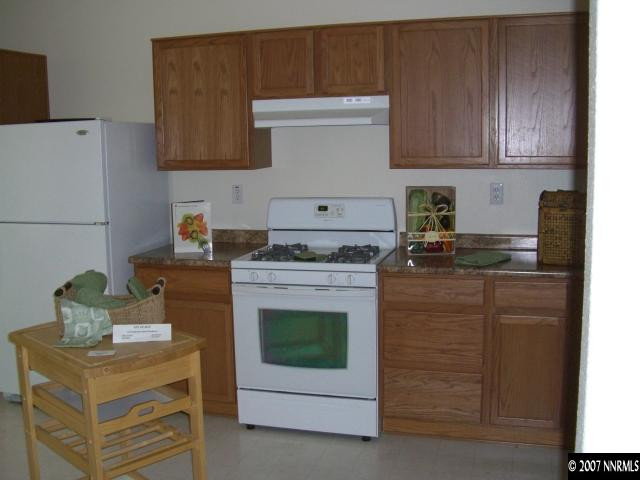 2305 Clementine Lane Reno, NV 89521 - Photo 4 of 9 a kitchen with granite countertop cabinets appliances and a counter space