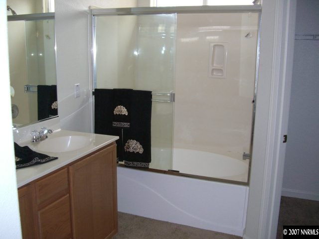2305 Clementine Lane Reno, NV 89521 - Photo 6 of 9 a bathroom with a sink a mirror and a shower