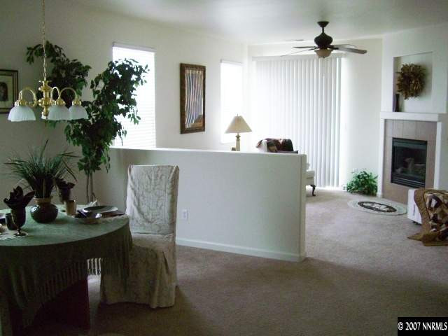 2305 Clementine Lane Reno, NV 89521 - Photo 8 of 9 a living room with furniture potted plant and a fireplace