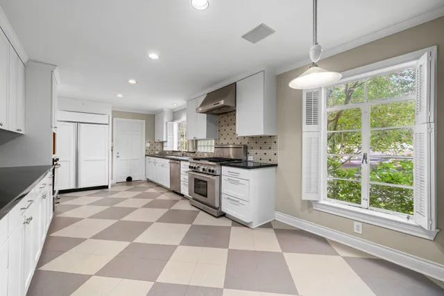 a kitchen with a stove a sink and a refrigerator