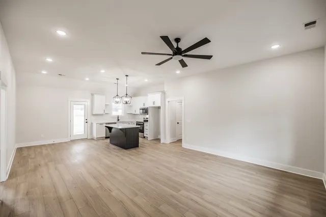 a kitchen with a cabinets and wooden floor