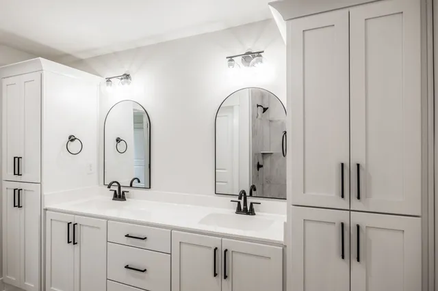 a bathroom with a double vanity sink and mirror