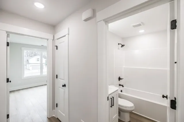 a bathroom with a granite countertop toilet a sink and bathtub