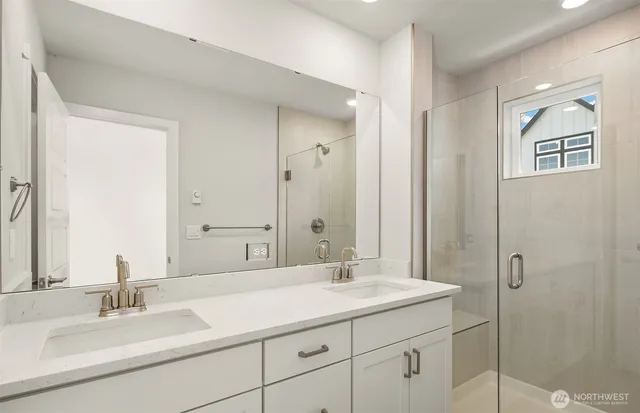 a bathroom with double vanity sinks double vanity and a mirror