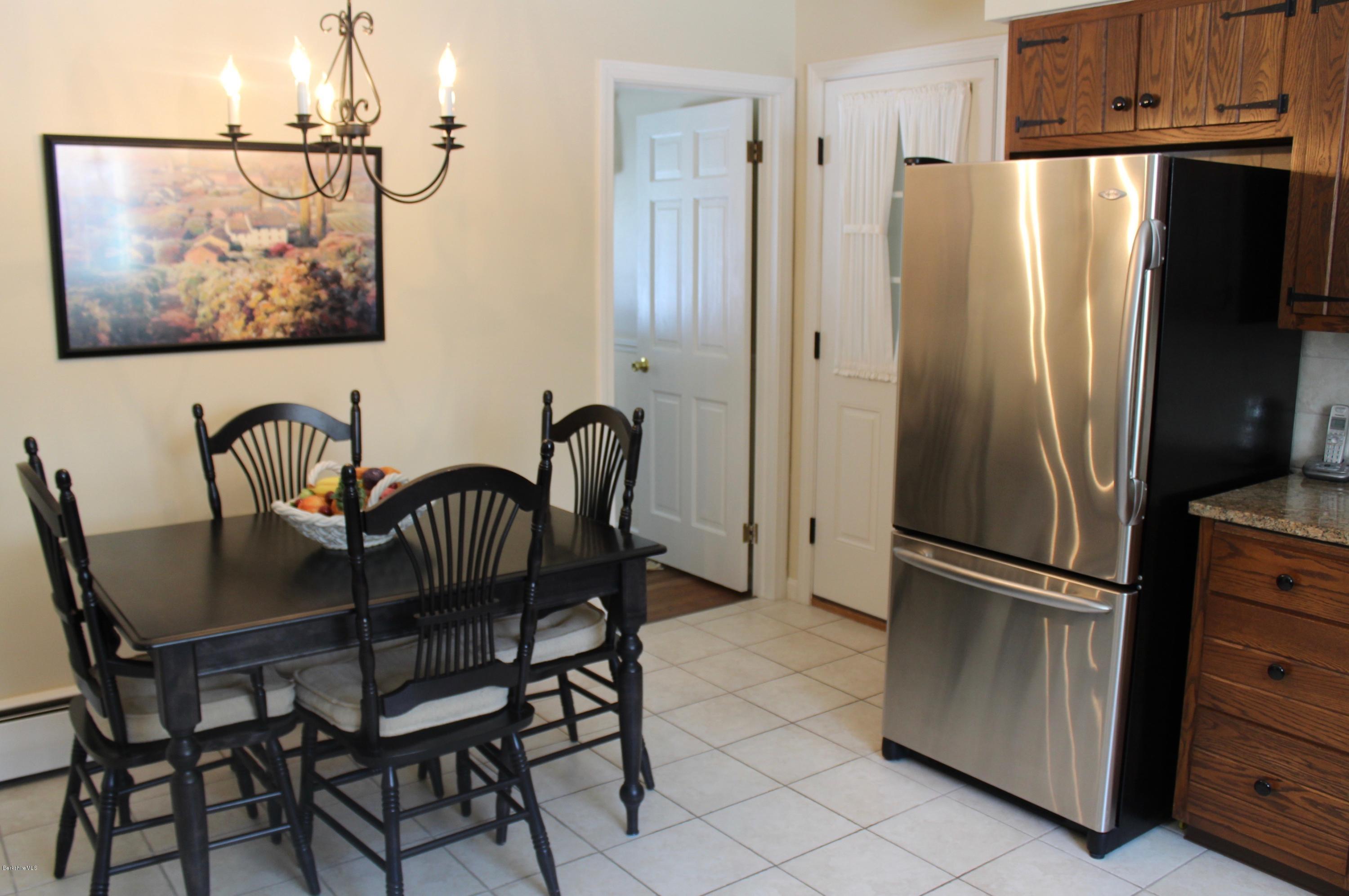 125 Dublin Road Richmond, MA 01201 - Photo 12 of 38 a kitchen with stainless steel appliances granite countertop a refrigerator and a dining table