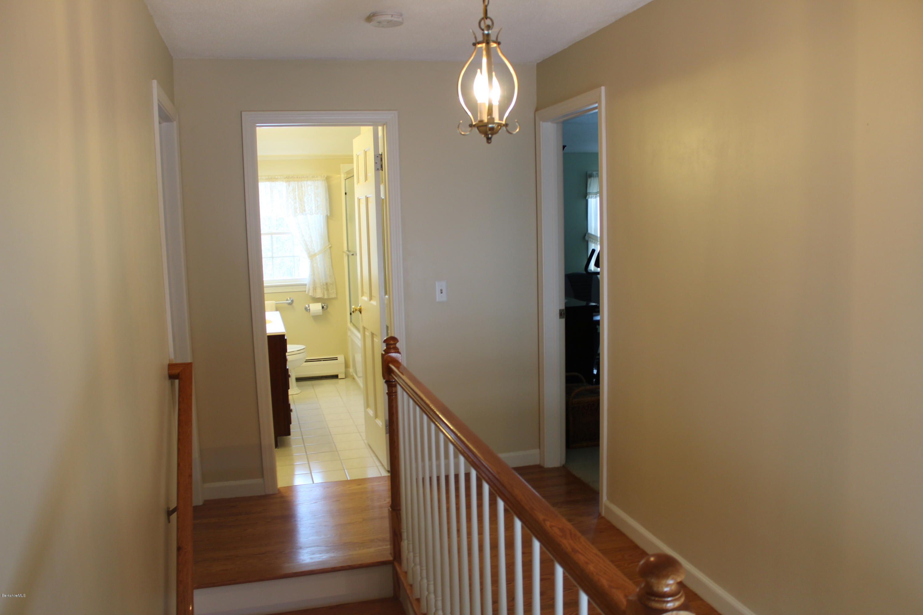 125 Dublin Road Richmond, MA 01201 - Photo 14 of 38 a view of a hallway with wooden floor and chandelier