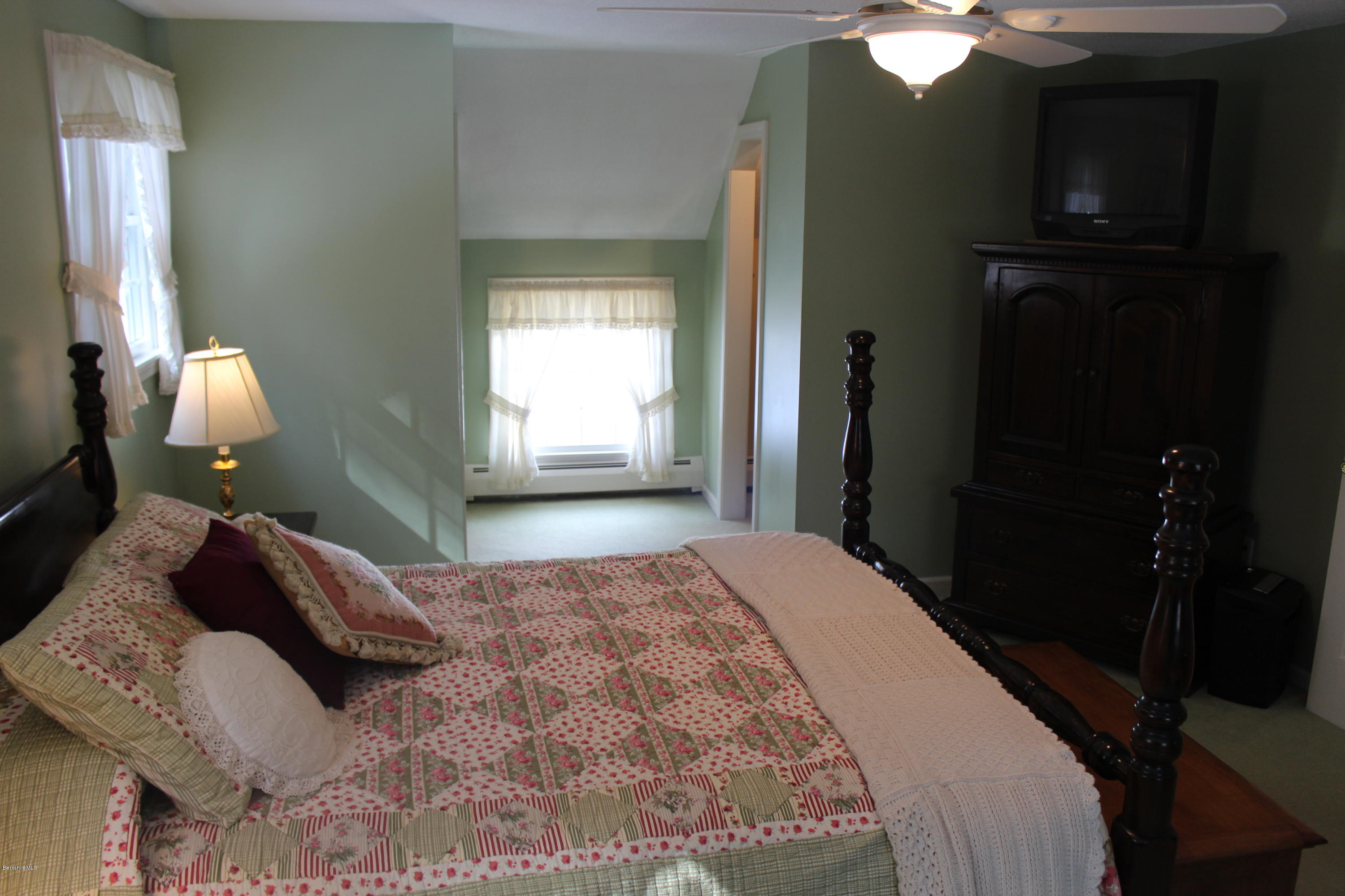 125 Dublin Road Richmond, MA 01201 - Photo 18 of 38 a bedroom with a bed and a chandelier