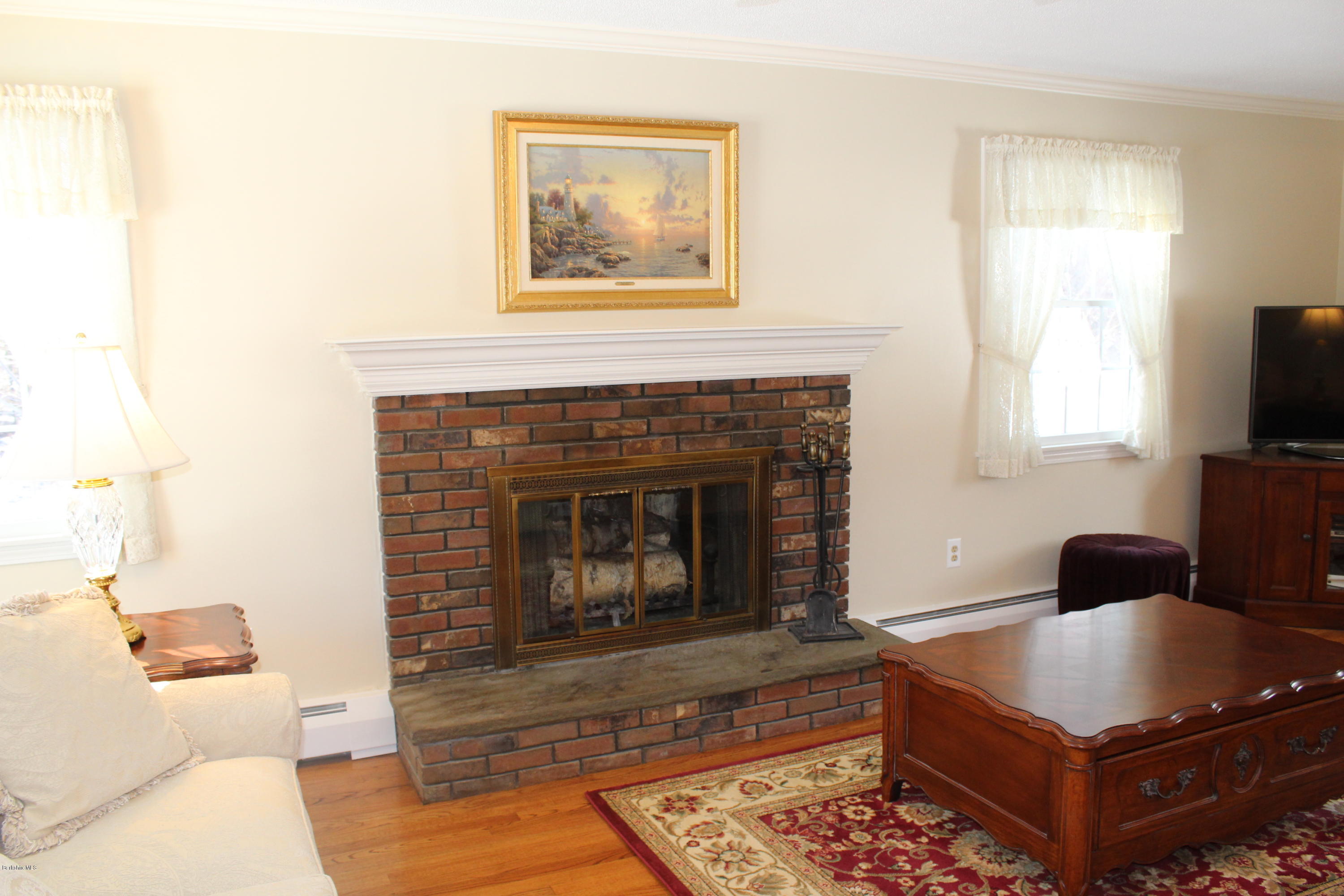 125 Dublin Road Richmond, MA 01201 - Photo 7 of 38 a living room with furniture a flat screen tv and a fireplace