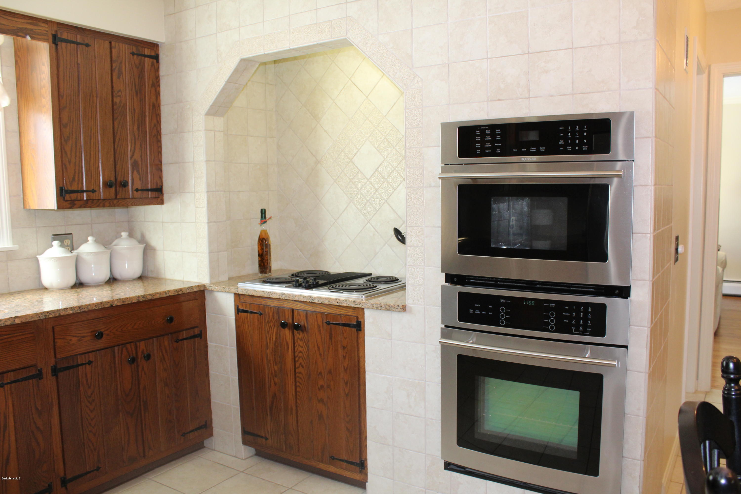 125 Dublin Road Richmond, MA 01201 - Photo 9 of 38 a kitchen with stainless steel appliances wooden cabinets and a stove top oven