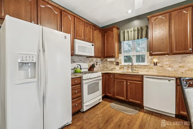 a kitchen with stainless steel appliances granite countertop a refrigerator sink and cabinets
