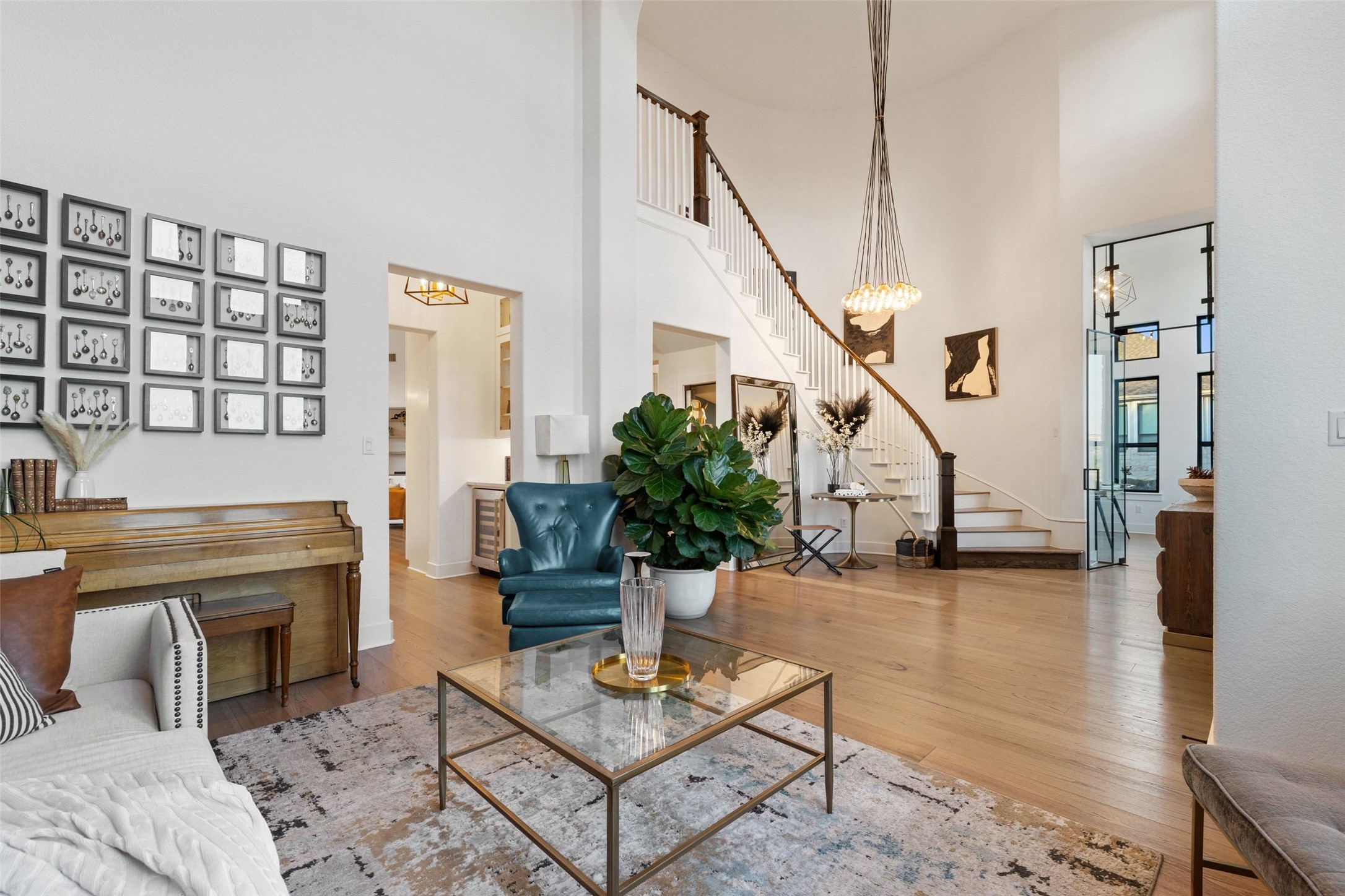 302 Lodestone Lane Austin, TX 78738 - Photo 4 of 40 An impressive two story foyer with curved staircase greets you upon arrival. The entry is also flanked with a custom home office featuring floor to ceiling glass door and a formal dining with service bar and whisky closet.