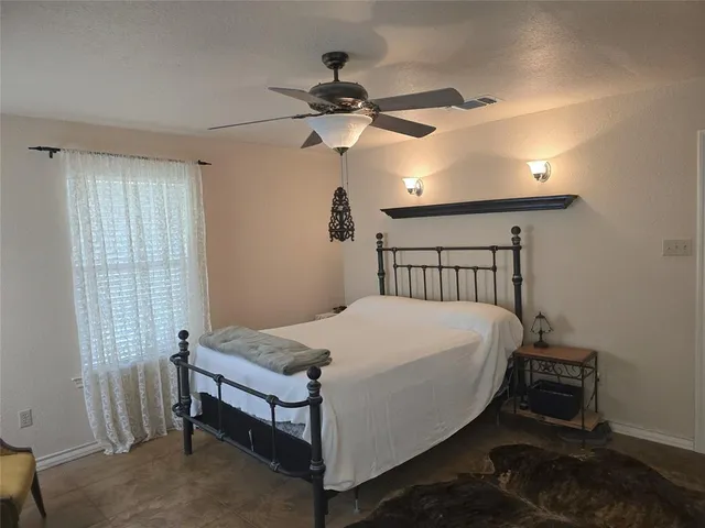 a kitchen with a dining table chairs refrigerator and cabinets