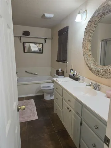 a bathroom with a sink a toilet and mirror
