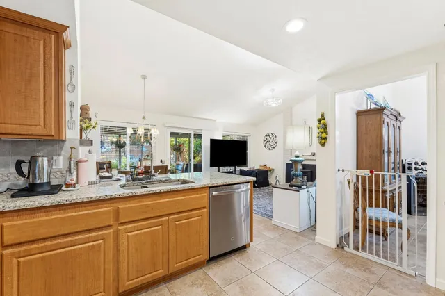 a kitchen with a sink and white cabinets