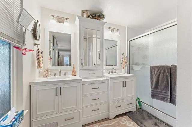 a bathroom with a double vanity sink and mirror