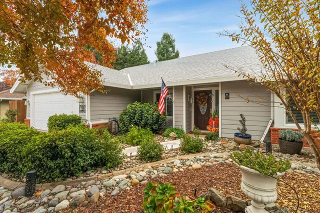 a front view of a house with garden