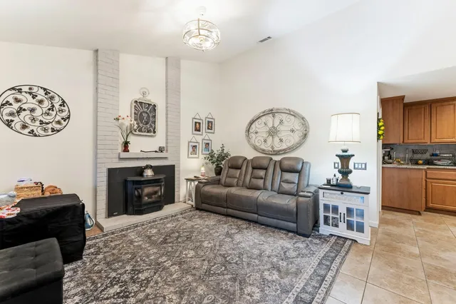 a living room with furniture a clock and a window