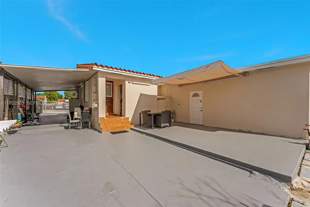 a view of a patio with table and chairs a barbeque and potted plants