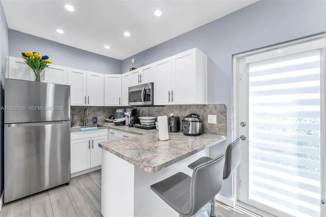 a bathroom with a sink a toilet and shower curtain