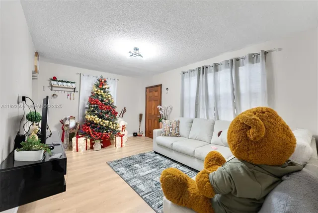 a living room with furniture and flowers