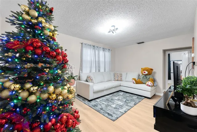 a living room with furniture and flowers