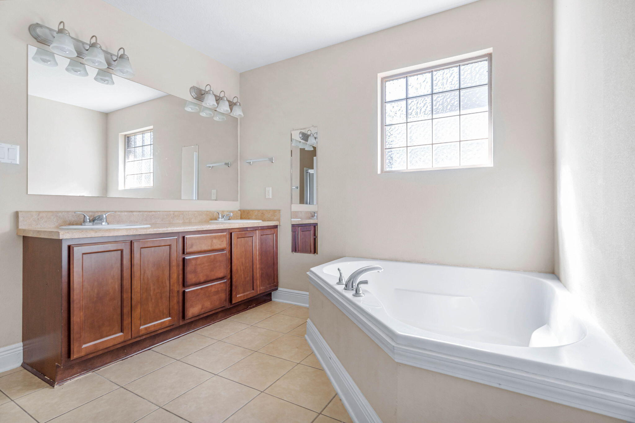 4561 Hermosa Road Crestview, FL 32539 - Photo 17 of 27 a spacious bathroom with a tub sink and mirror