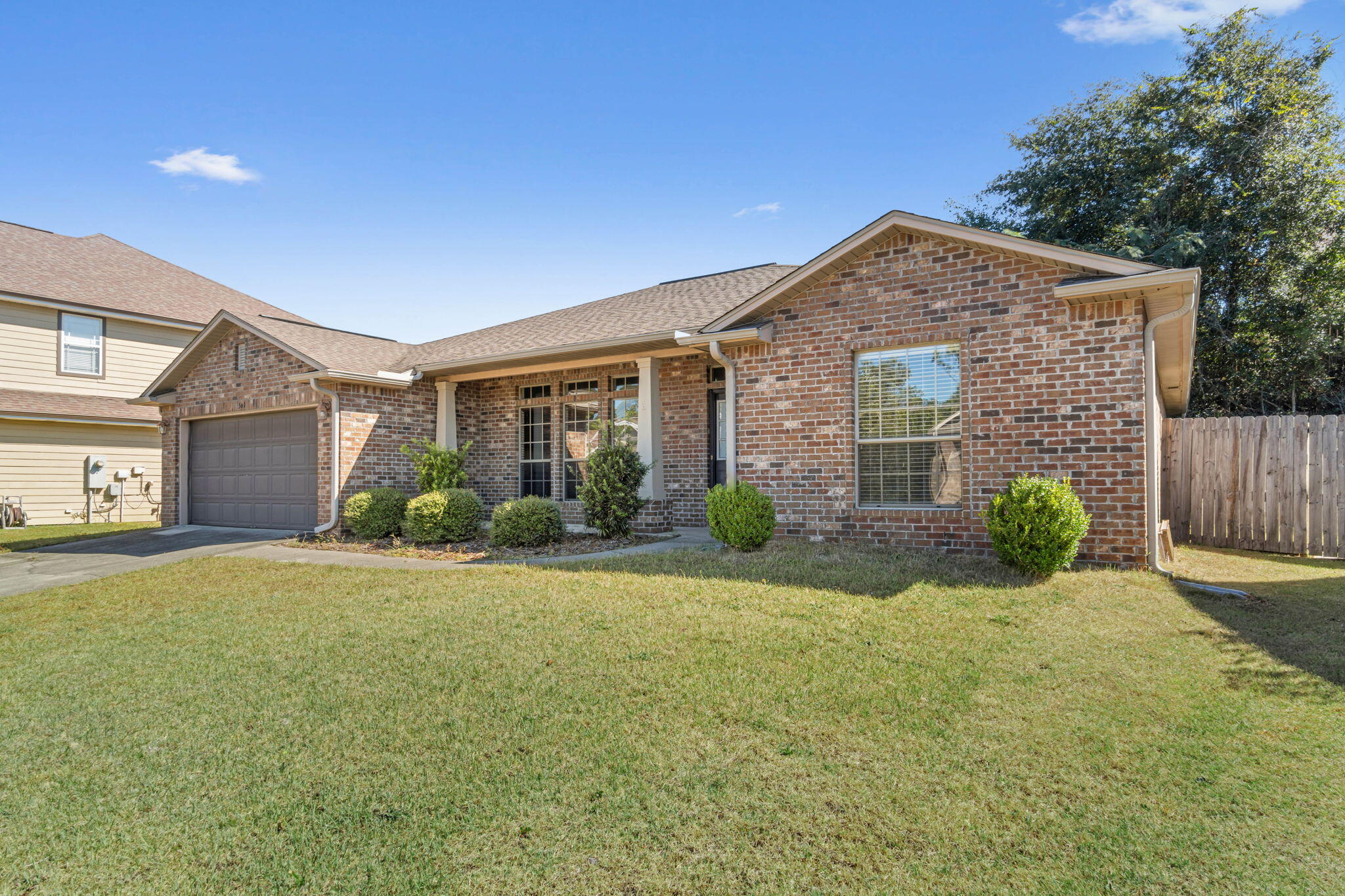 4561 Hermosa Road Crestview, FL 32539 - Photo 2 of 27 a front view of a house with yard and green space