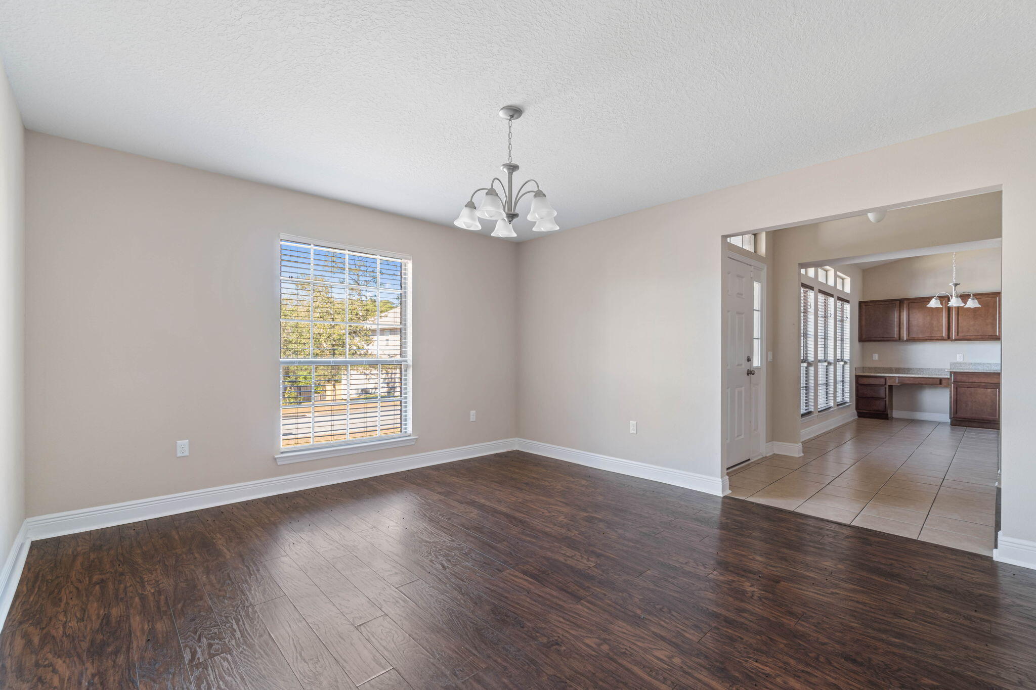 4561 Hermosa Road Crestview, FL 32539 - Photo 8 of 27 an empty room with wooden floor and windows