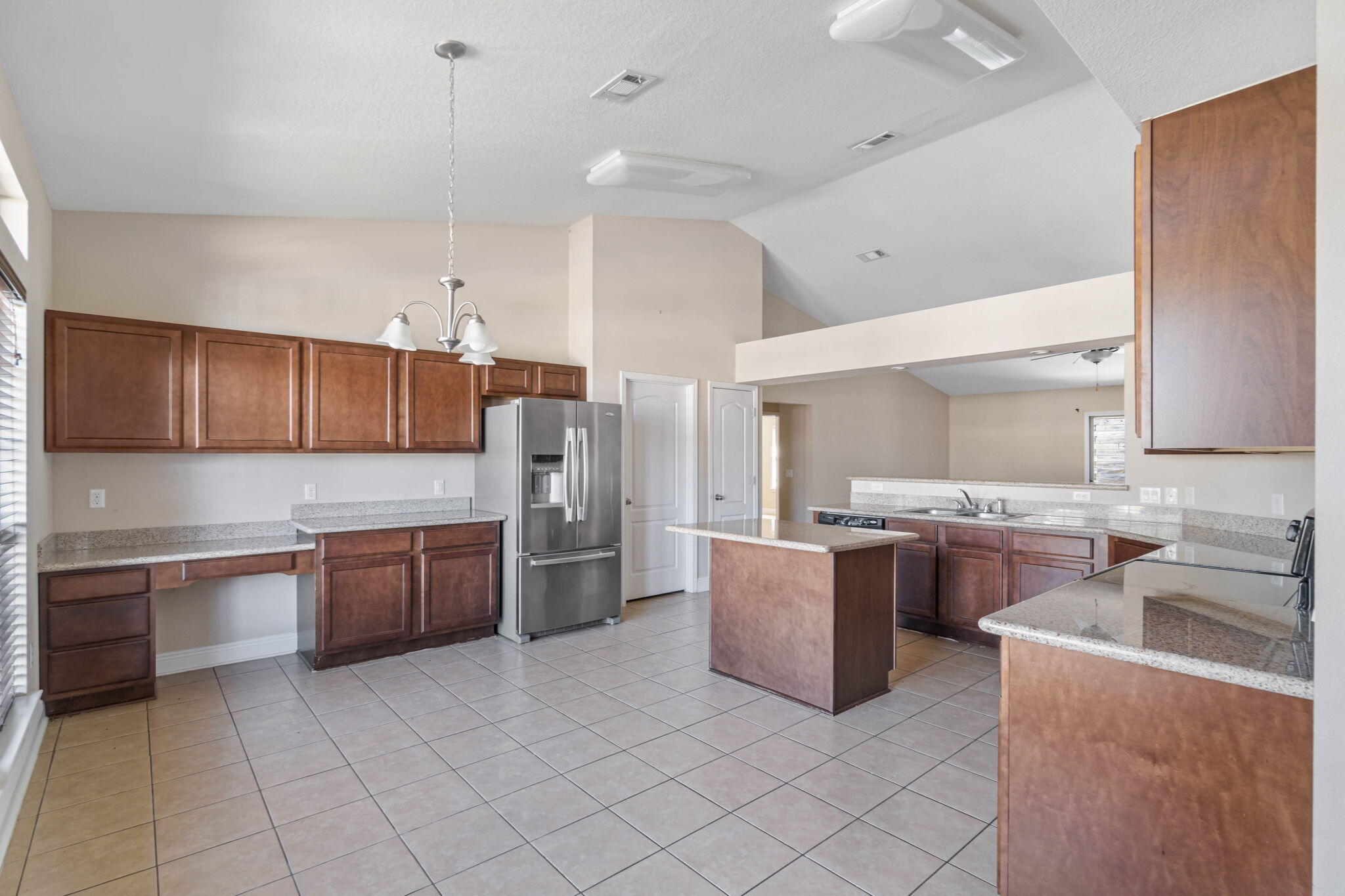 4561 Hermosa Road Crestview, FL 32539 - Photo 10 of 27 a large kitchen with cabinets and stainless steel appliances