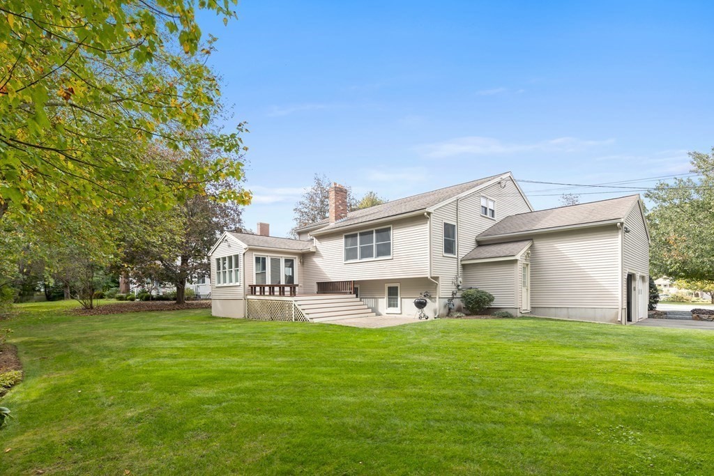 56 Sherburne Road South Lexington, MA 02421 - Photo 39 of 42 a front view of a house with a garden and trees