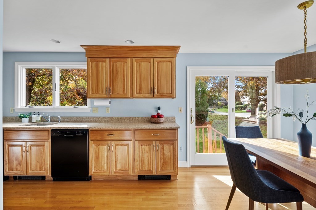 56 Sherburne Road South Lexington, MA 02421 - Photo 4 of 42 a kitchen with stainless steel appliances granite countertop a stove top oven a sink dishwasher and wooden cabinets with wooden floor