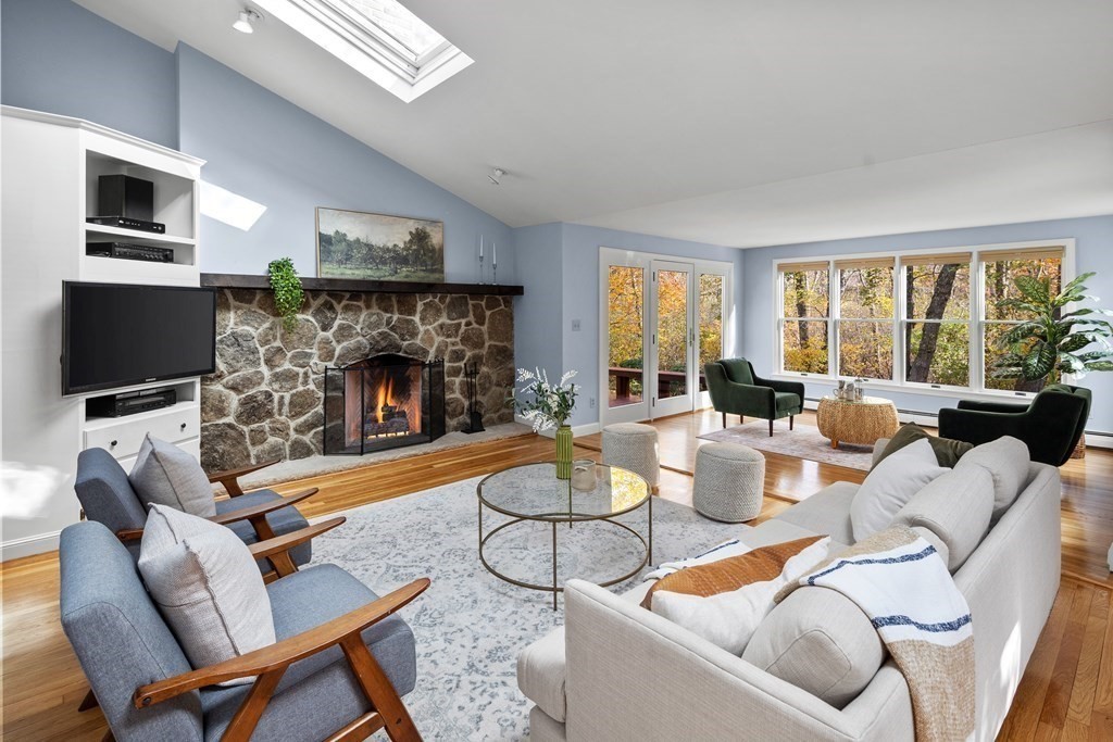 56 Sherburne Road South Lexington, MA 02421 - Photo 10 of 42 a living room with furniture a flat screen tv and a fireplace