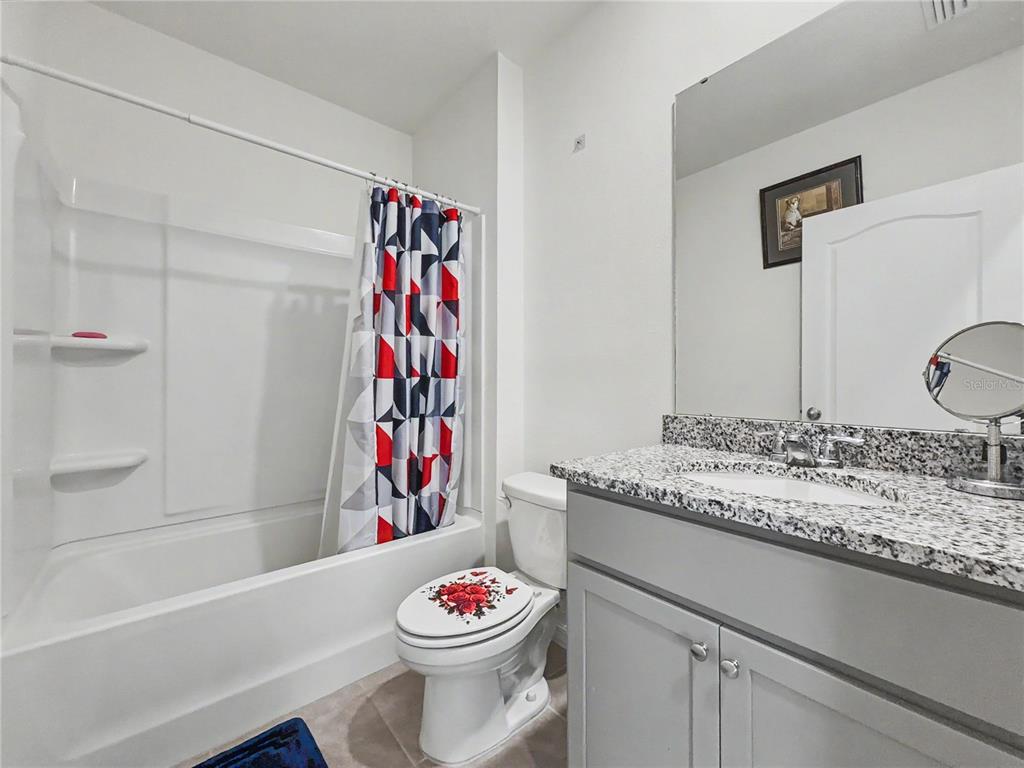 2085 Doe Run Drive Davenport, FL 33837 - Photo 23 of 44 a bathroom with a sink and a mirror