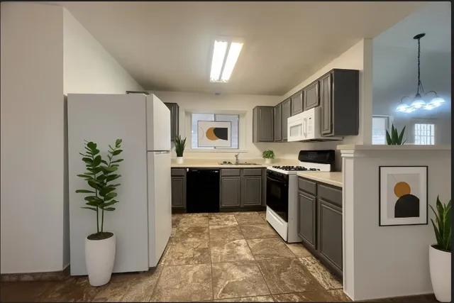 a kitchen with stainless steel appliances a refrigerator a sink a stove and cabinets