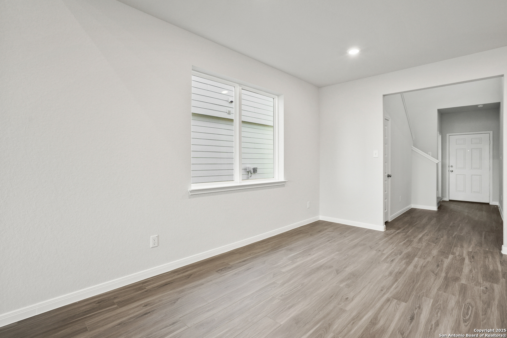 13636 Helton Pass St. Hedwig, TX 78152 - Photo 4 of 34 an empty room with wooden floor and windows