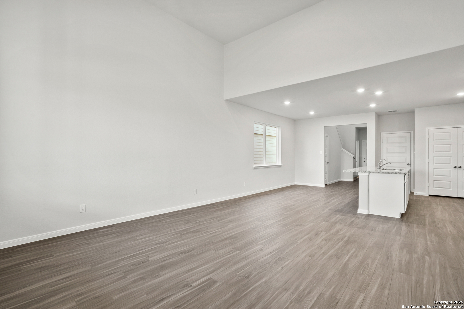 13636 Helton Pass St. Hedwig, TX 78152 - Photo 8 of 34 a view of an empty room with wooden floor and a window