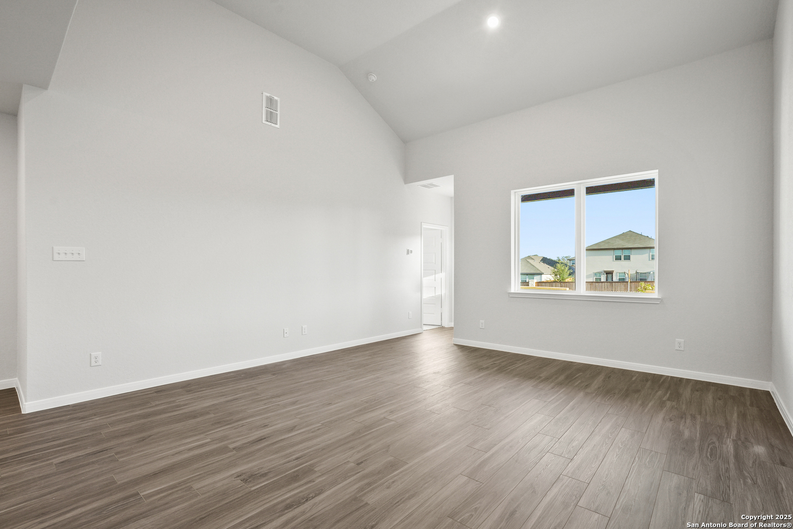 13636 Helton Pass St. Hedwig, TX 78152 - Photo 9 of 34 an empty room with wooden floor and windows