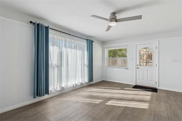 a view of a livingroom with a ceiling fan and window