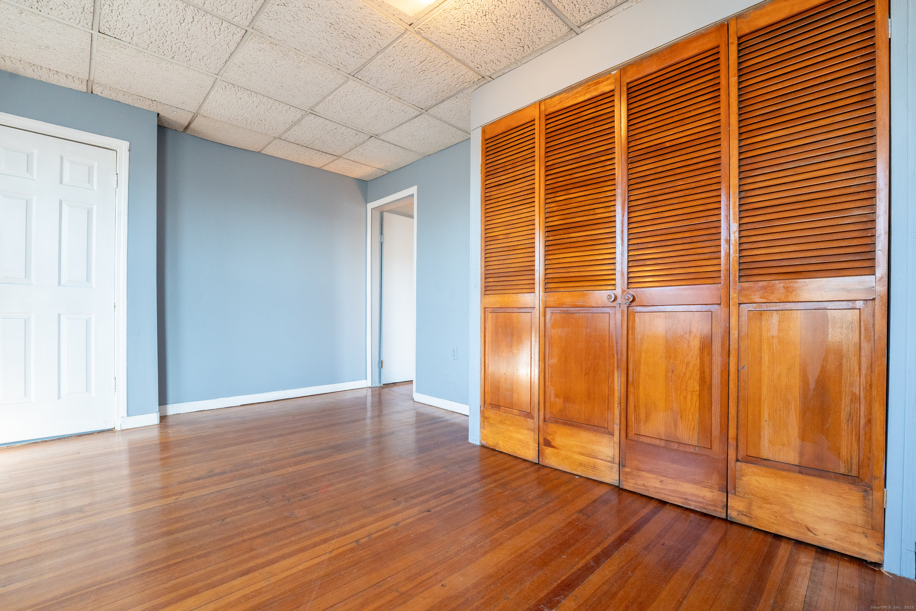1368 East Main Street, Unit 4 Bridgeport, CT 06608 - Photo 4 of 14 a view of empty room with wooden floor and fan