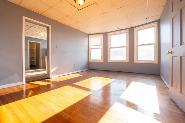 a view of empty room with window and floor to ceiling window