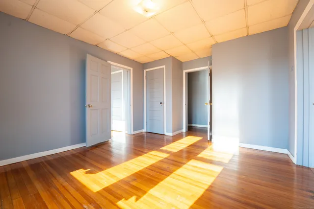 a view of a room with wooden floor