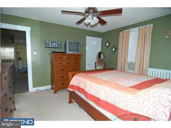 1024 Fern Avenue Reading, PA 19607 - Photo 10 of 12 a bed room with a bed and a chandelier