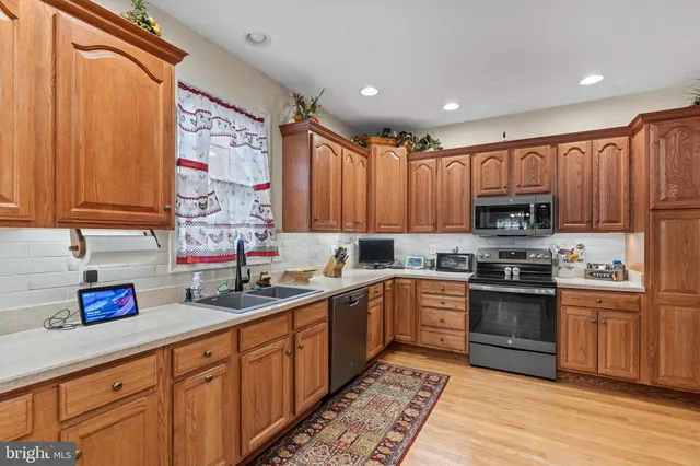 a kitchen with stainless steel appliances granite countertop a sink and cabinets